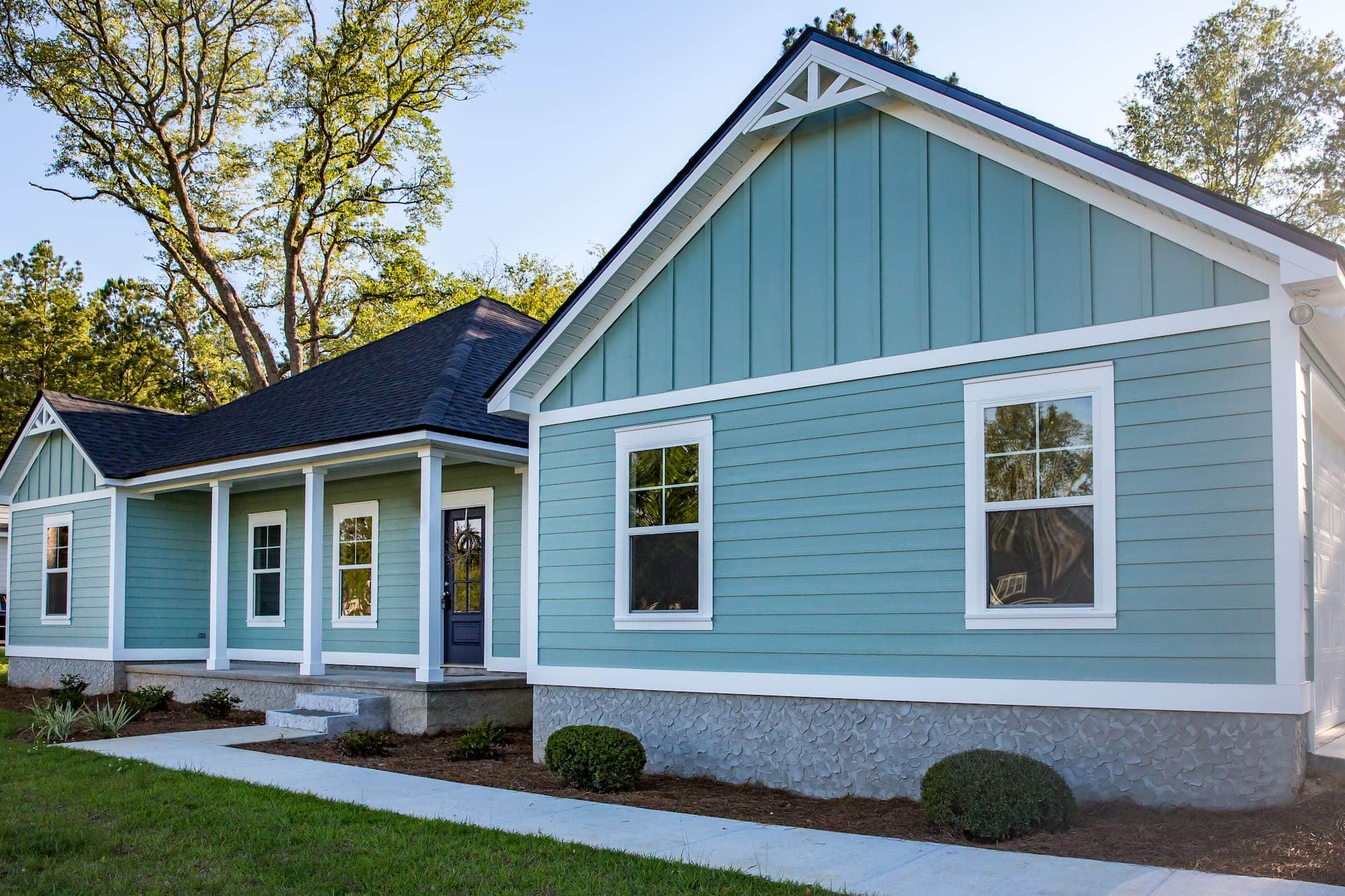 Bright blue vinyl siding installation